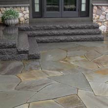 Large irregular shaped bluestone patio set in stone dust, with Caledonia granite steps